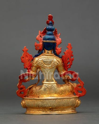 back view of green tara statue with detailed carvings and lotus pedestal
