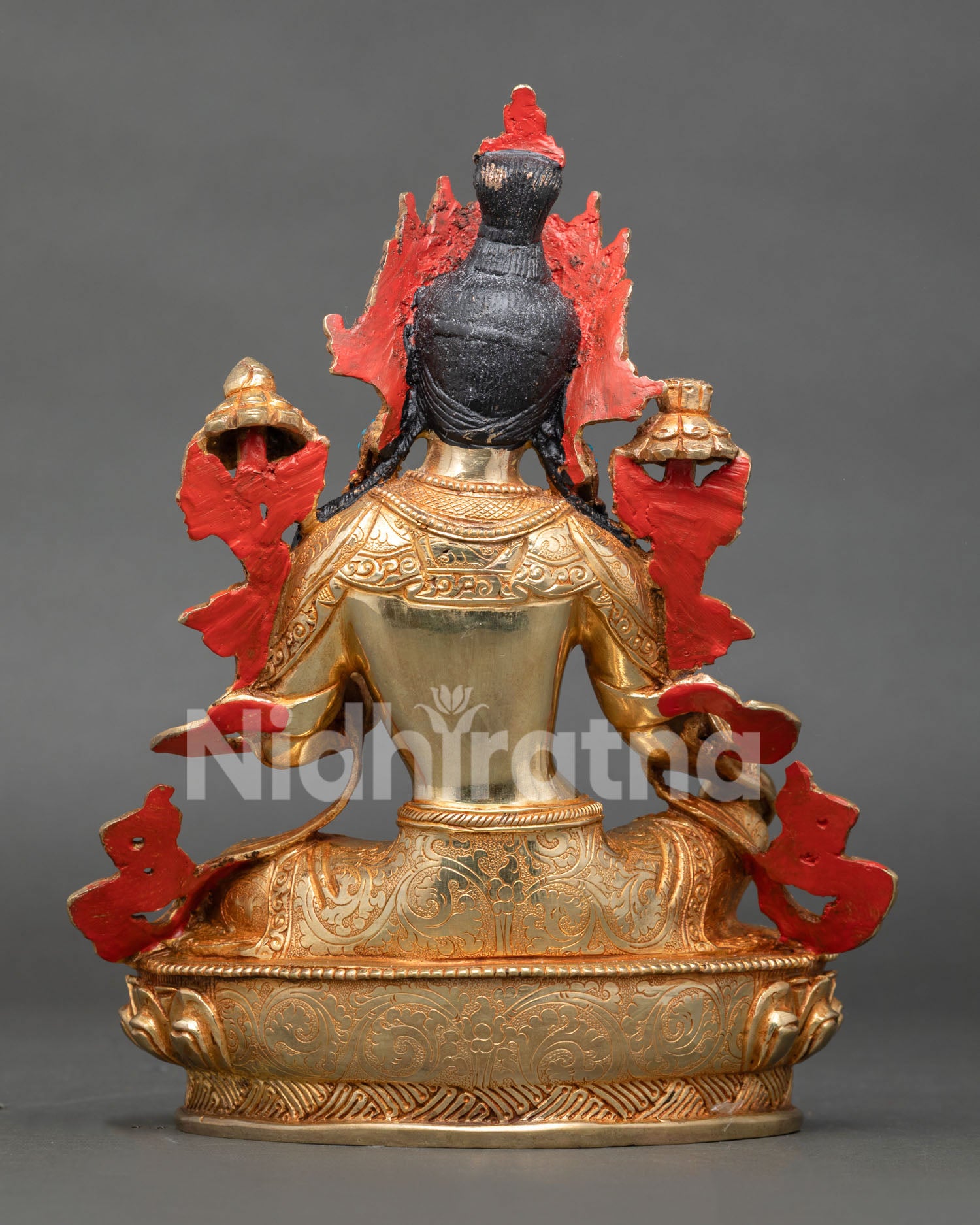 Back view of Green Tara statue with detailed halo and lotus base carvings