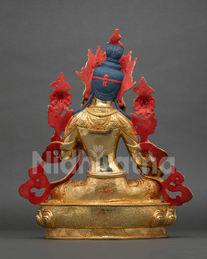 Back view of Green Tara statue with engraved 24K gold fire gilding and red painted backdrop