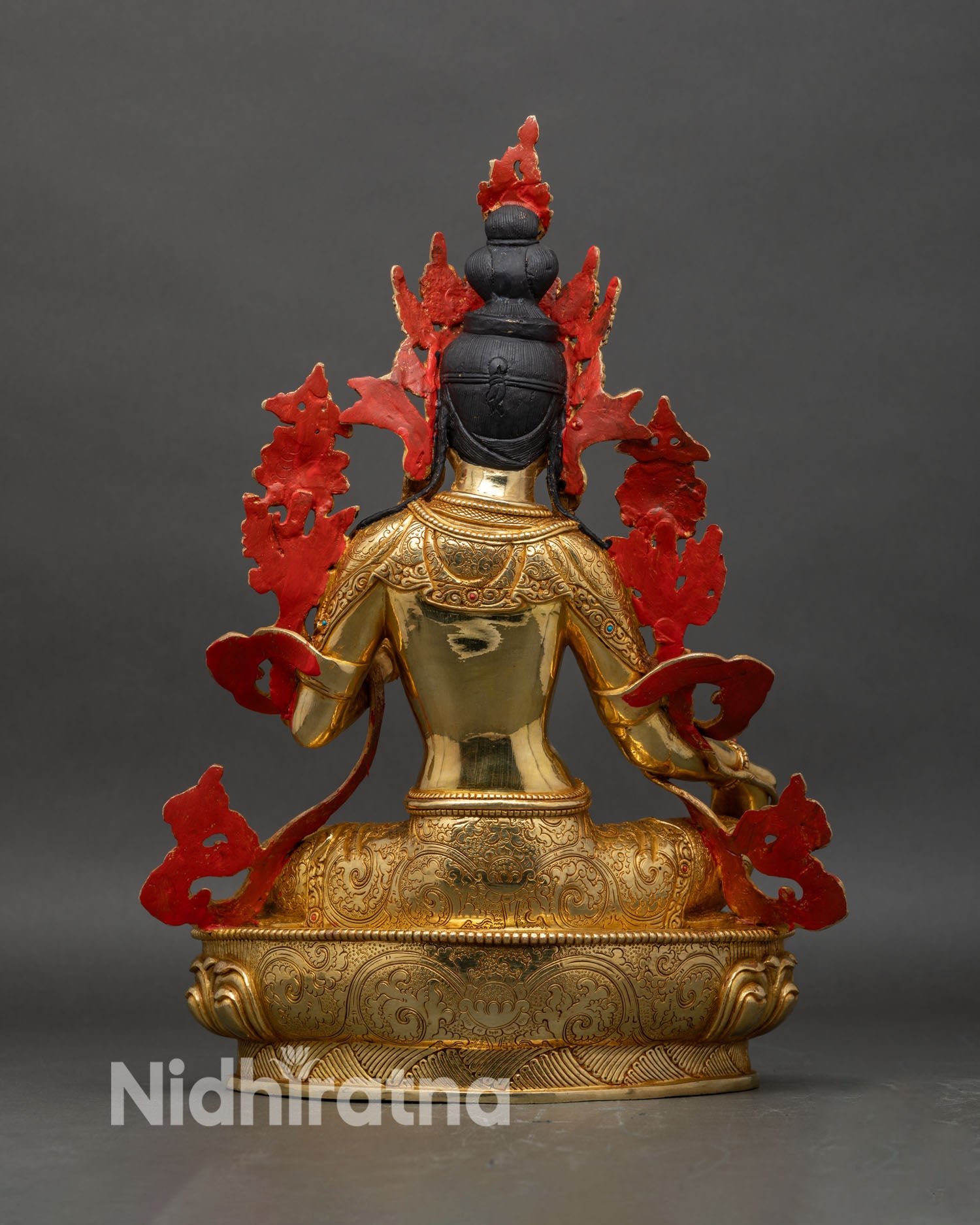 Back view of Green Tara statue with engraved lotus base and sculpted robe patterns