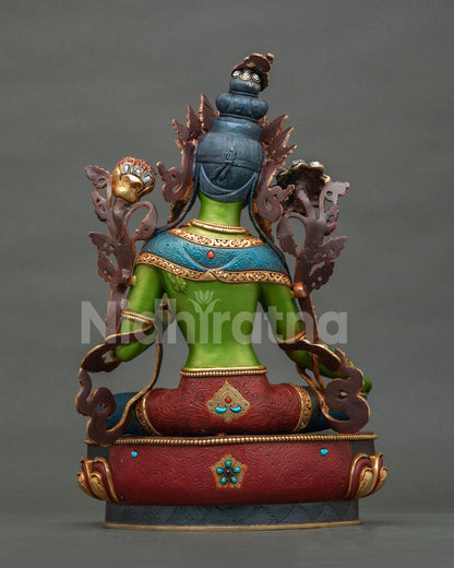Back view of Green Tara statue with ornate backrest, red and blue robes and lotus base