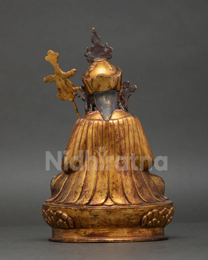 back view of guru norlha statue featuring vajra symbol and detailed craftsmanship
