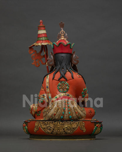 Back view of Guru Norlha Statue, gold gilded robe and khatvanga staff detail