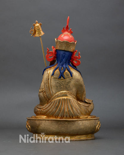 back view of guru norlha statue with lotus throne and finely engraved robe patterns