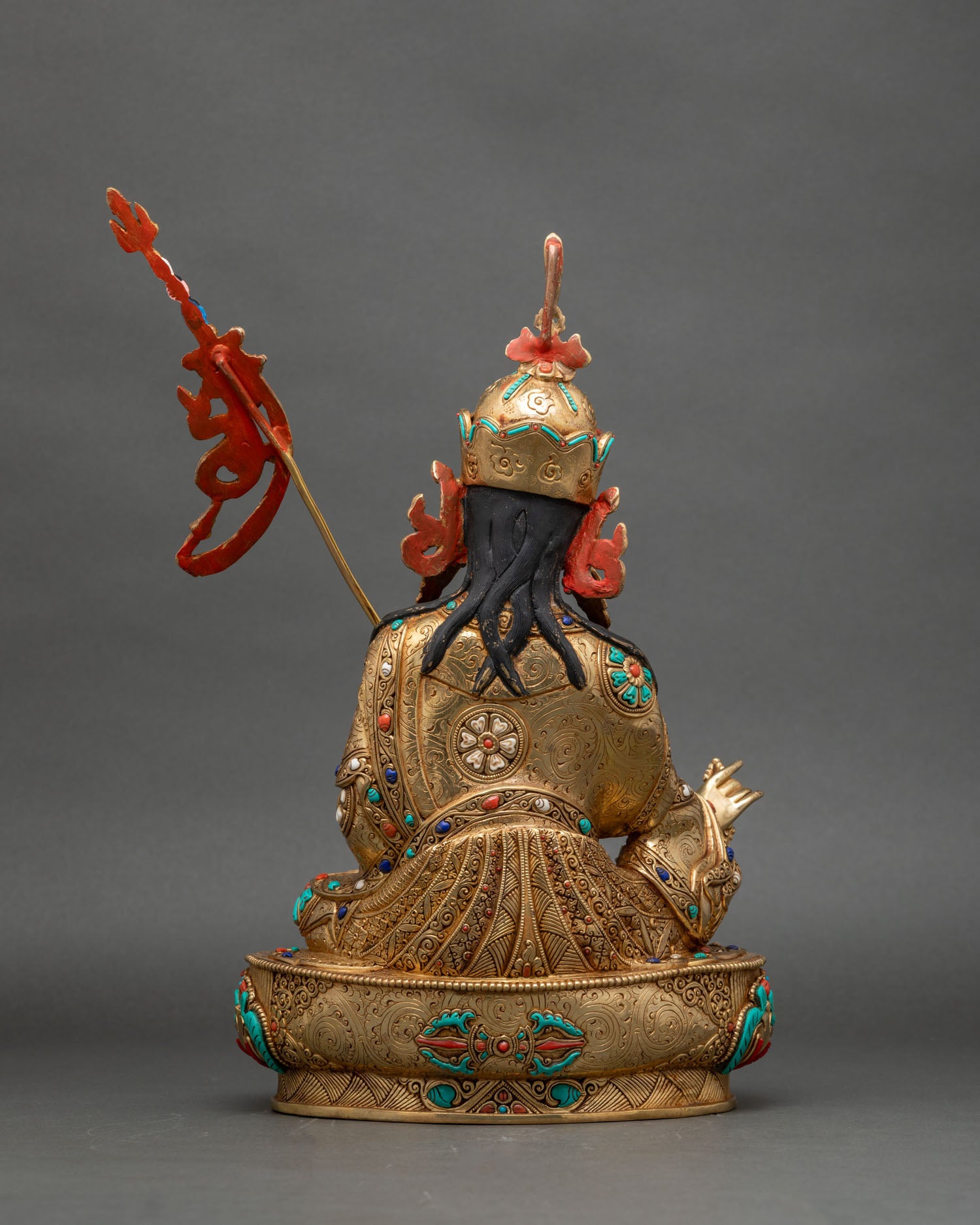Back view of Guru Rinpoche statue, carved robes and lotus pedestal, Nepalese sacred art