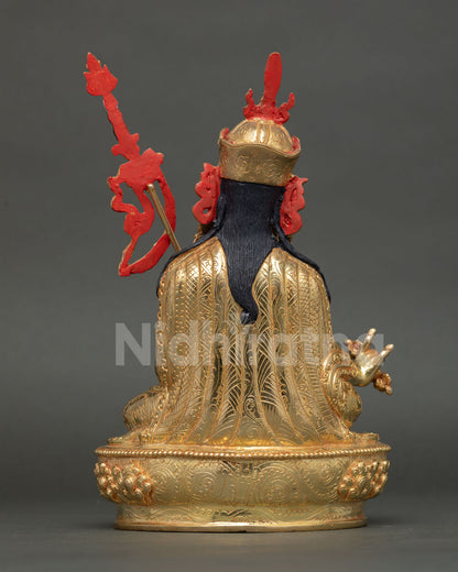 Back view of Guru Rinpoche statue revealing detailed robe carving and traditional Newari artisan metalwork in copper and gold finish.