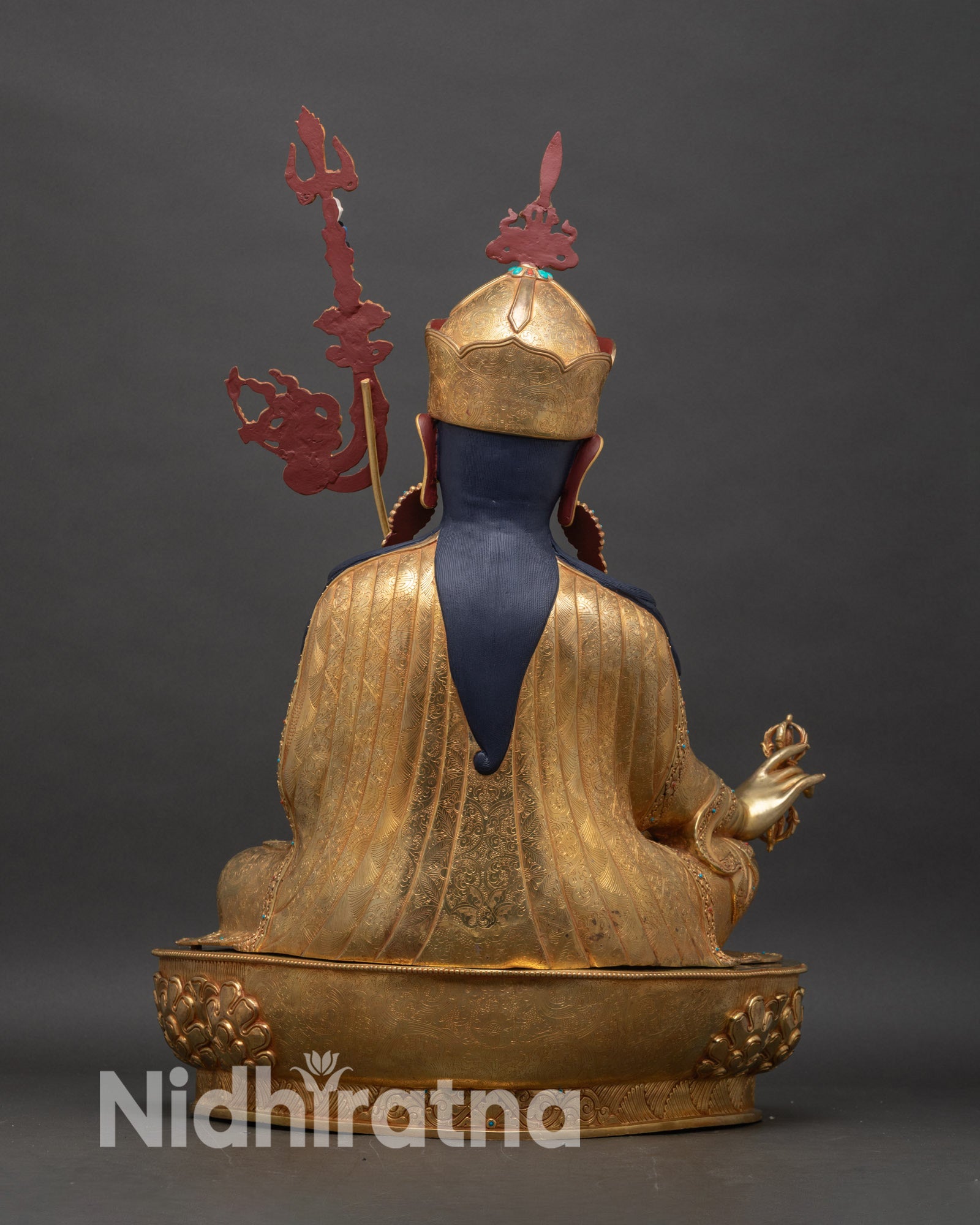 Back view of Guru Rinpoche statue showing detailed robe patterns and copper craftsmanship