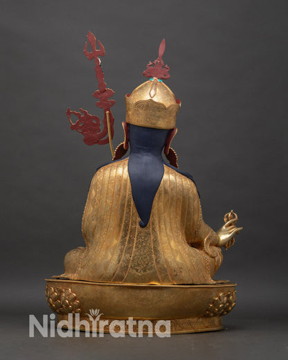 Back view of Guru Rinpoche statue showing detailed robe patterns and copper craftsmanship