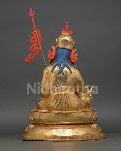 Back view of Guru Rinpoche statue showing detailed robes, khatvanga staff and artisan craftsmanship