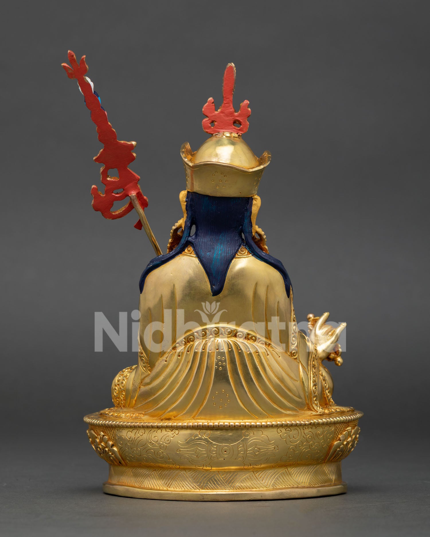 Back view of Guru Rinpoche statue showing ornate robes, halo, and detailed craftsmanship
