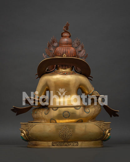 Back view of hand-carved gold fire-gilded copper Dzambhala Buddhist sculpture.