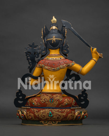 Back view of hand-painted Manjushri statue with braided hair and lotus pedestal