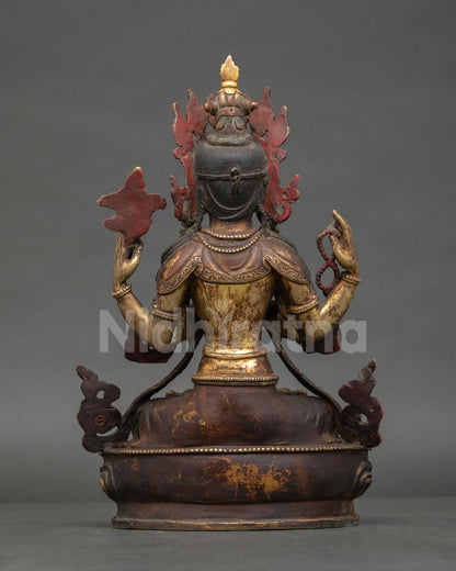 Back view of handcrafted Avalokiteshvara statue showing detailed robe patterns and copper work