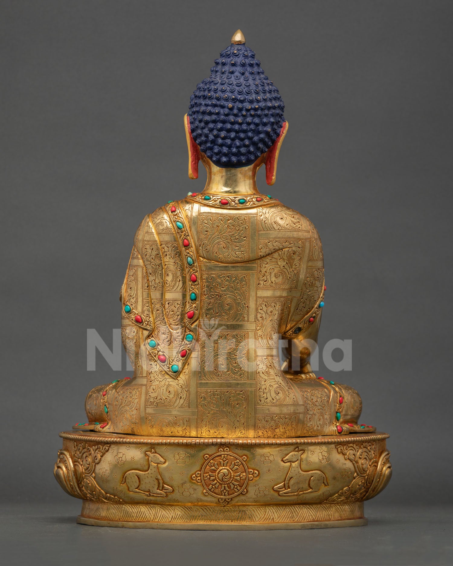 Back view of handcrafted Buddha Shakyamuni statue showing Nepalese craftsmanship and lotus pedestal