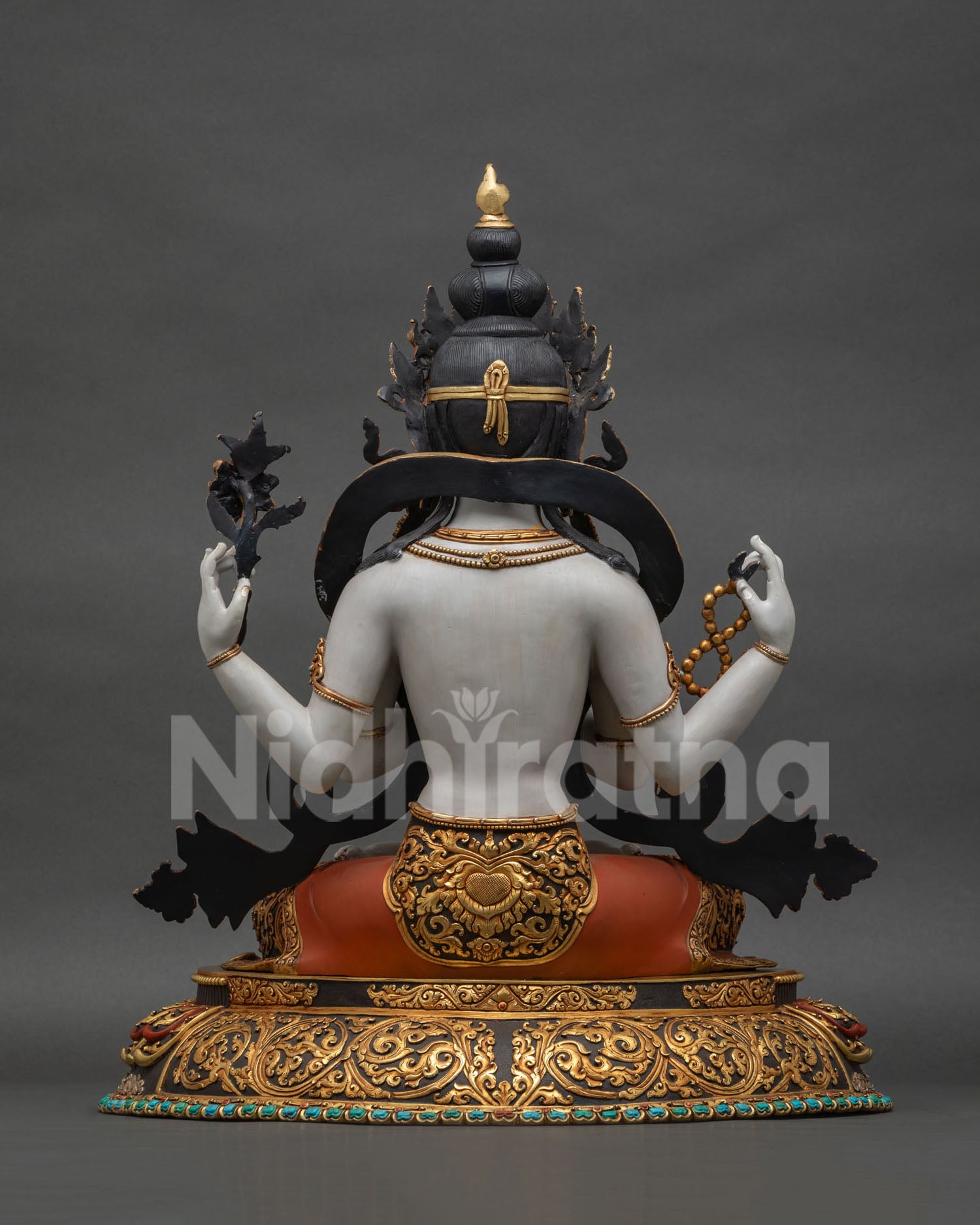 Back view of handcrafted Chenrezig Avalokiteshvara statue with detailed repoussé patterns
