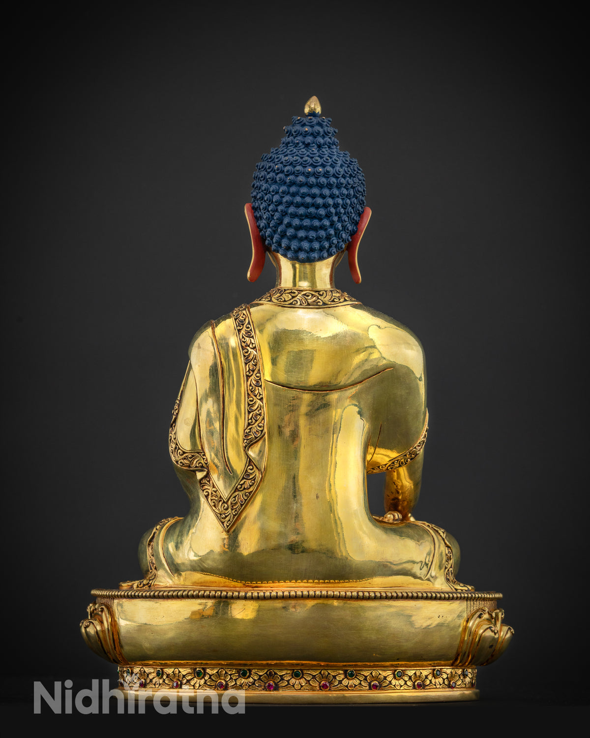 Back view of handcrafted copper Shakyamuni Buddha statue with ornate design