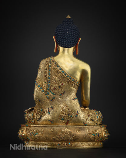 Back view of handcrafted copper Shakyamuni Buddha statue with ornate robe design