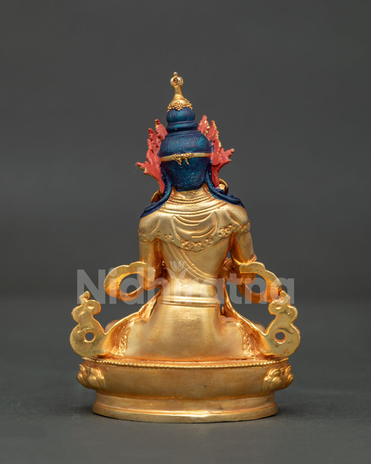 Back view of handcrafted copper Vajrasattva statue with intricate gold gilded details from Patan Nepal.
