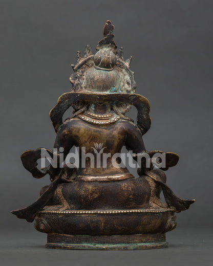 Back view of handcrafted Dzambhala statue showing intricate Newari copper craftsmanship.