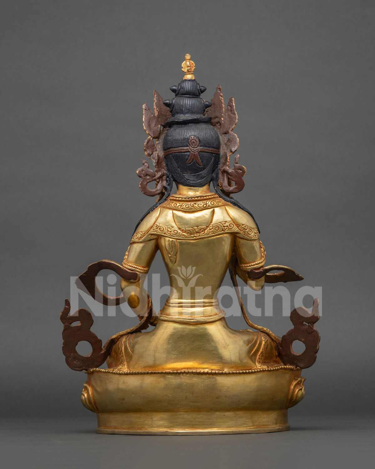 Back view of handcrafted gold gilded Vajrasattva statue with hair topknot and engraved robe, lotus base