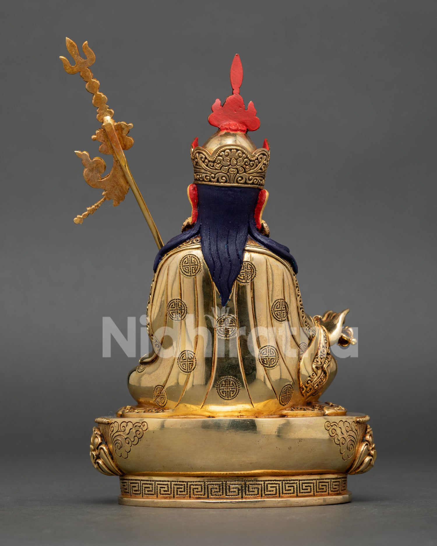 Back view of handcrafted Guru Rinpoche Statue displaying traditional Nepalese artistry, detailed robes, and sacred Buddhist sculpture design.