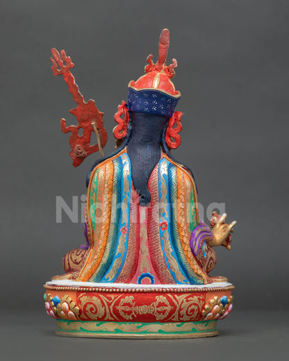 Back view of handcrafted Guru Rinpoche statue with detailed copper sculpture and royal robe.