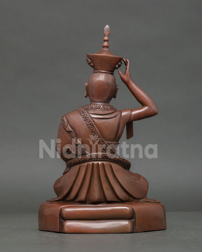 Back View of Handcrafted Karmapa Copper Statue with Intricate Robe Carvings.
