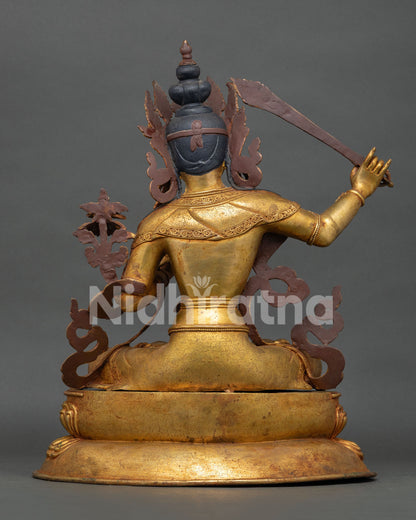 Back view of handcrafted Manjushri statue with gold gilded copper design and traditional Nepalese Buddhist craftsmanship
