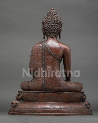 back view of handcrafted shakyamuni buddha statue with detailed robe engravings