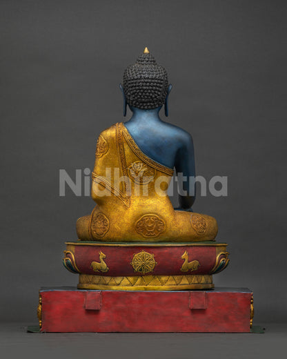 Back view of handmade copper Akshobhya Buddha statue with gold gilded throne from Nepal