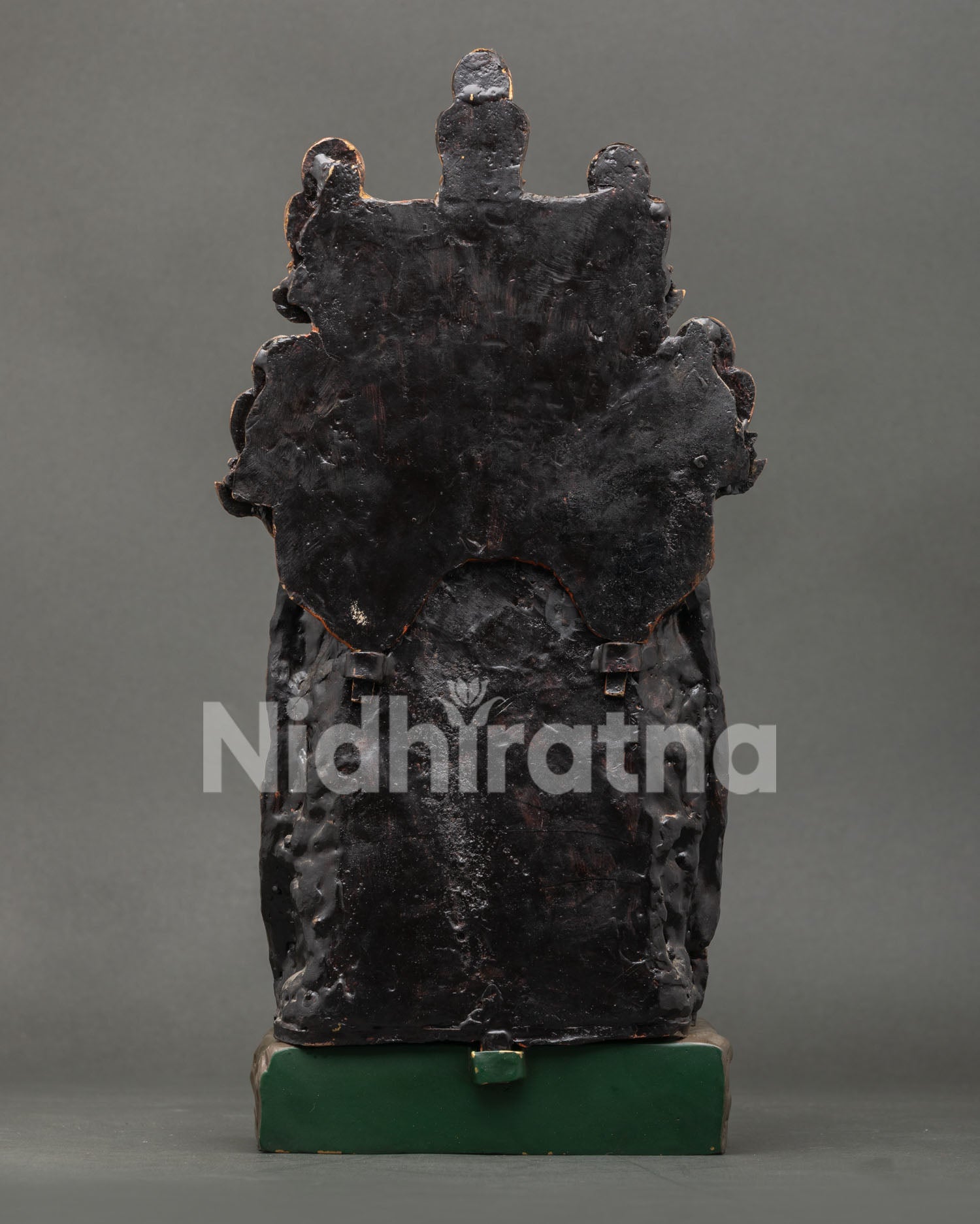 Back view of handmade copper Medicine Buddha statue, traditional Nepali artistry
