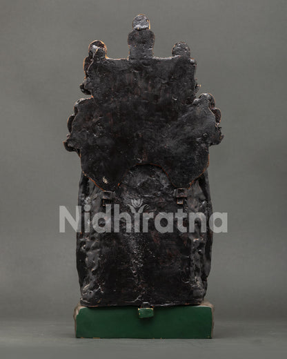 Back view of handmade copper Medicine Buddha statue, traditional Nepali artistry