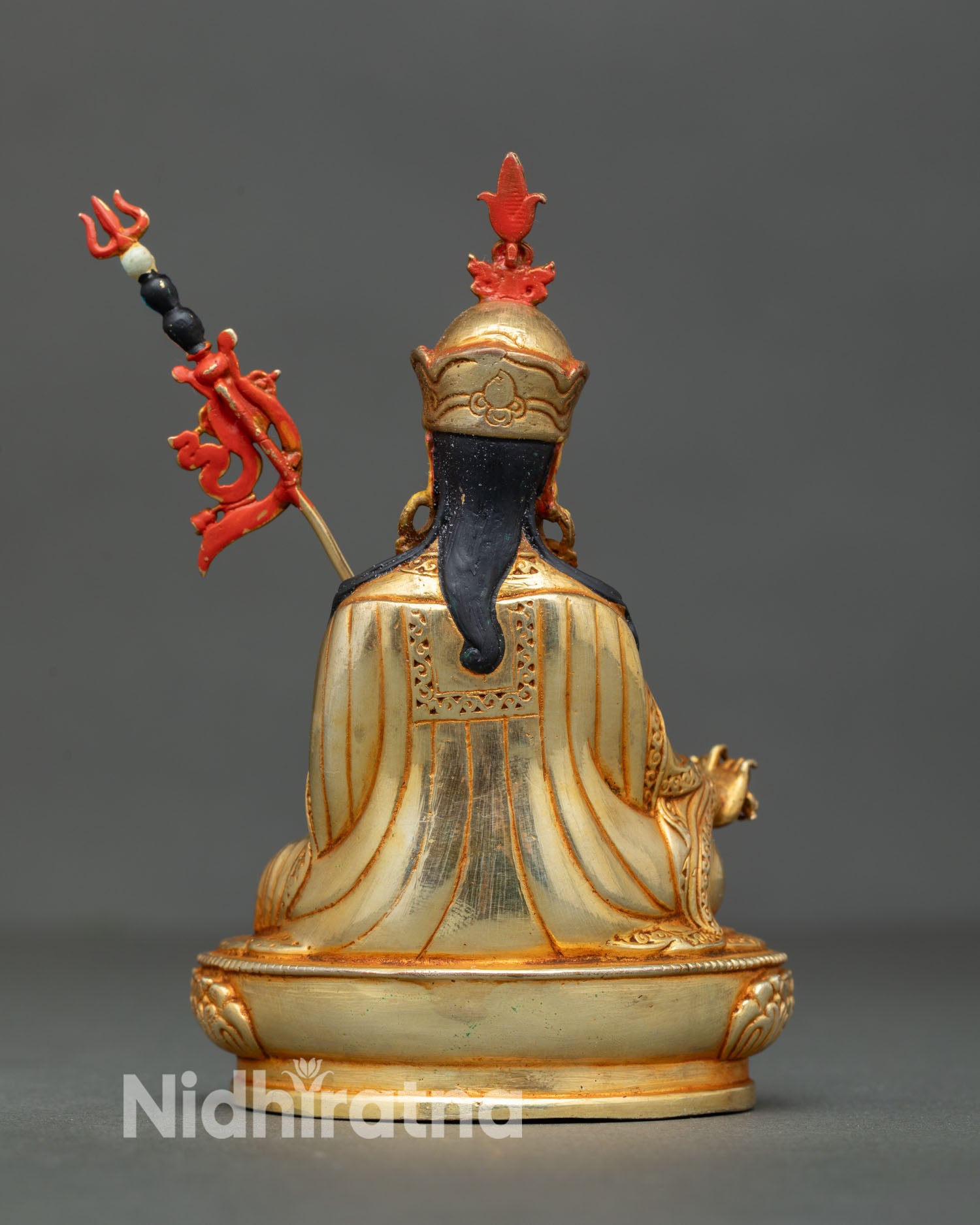 Back view of handmade Guru Rinpoche statue from Patan Nepal featuring ornate copper carving feather crown and richly detailed spiritual Vajrayana artwork