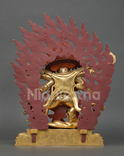 Back view of a handmade Mahakala statue showcasing intricate Himalayan craftsmanship and a detailed flame halo design