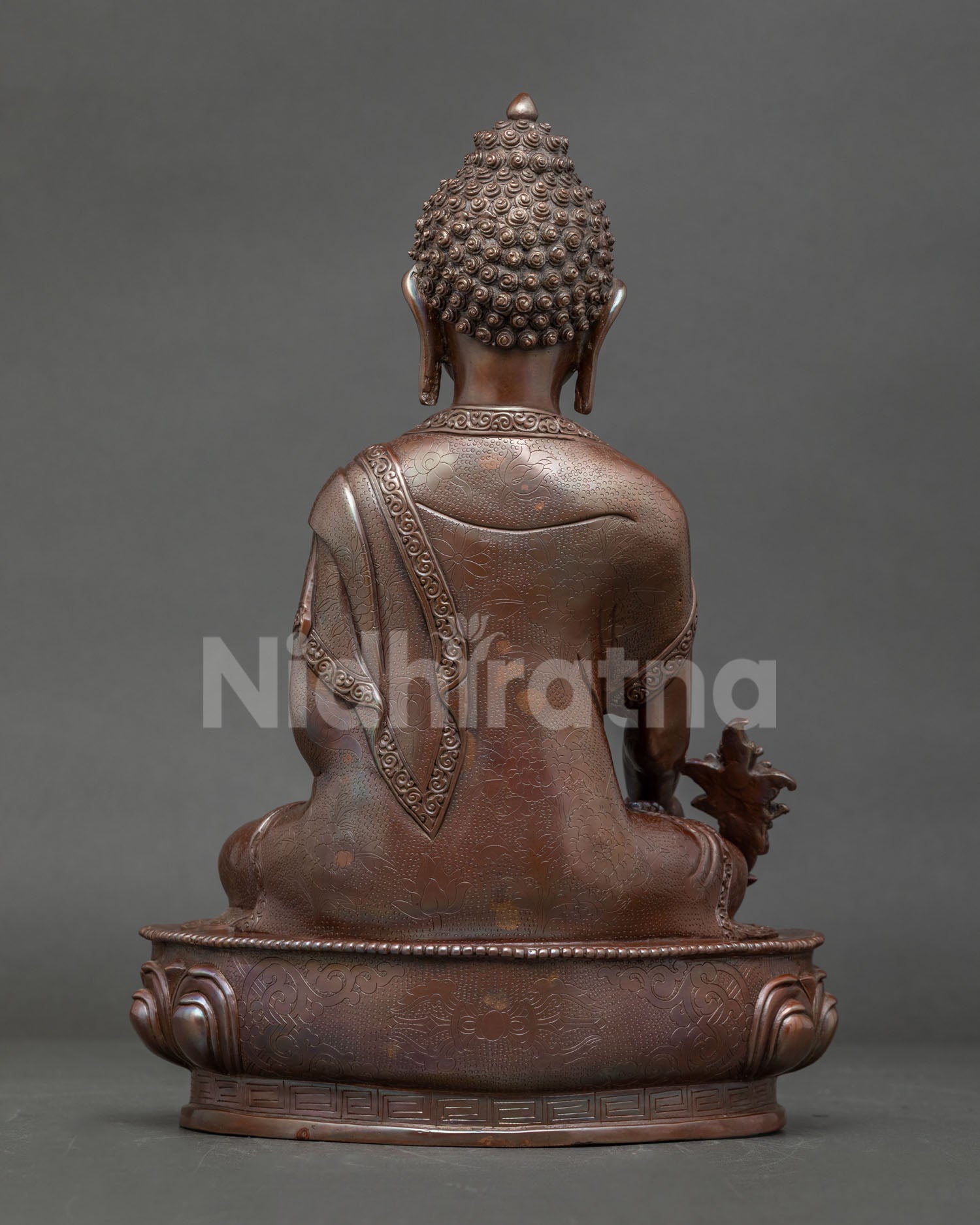 Back view of handmade Medicine Buddha sculpture lost wax casting detail Himalayan Buddhist altar statue