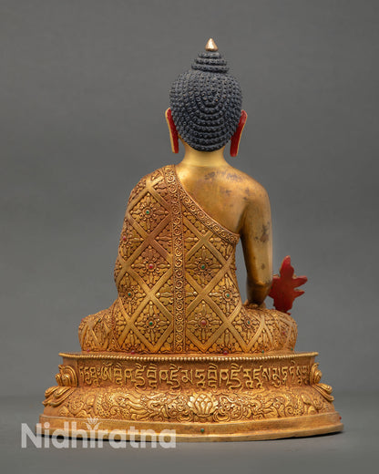 Back view of handmade Medicine Buddha statue featuring ornate copper detailing richly carved lotus pedestal
