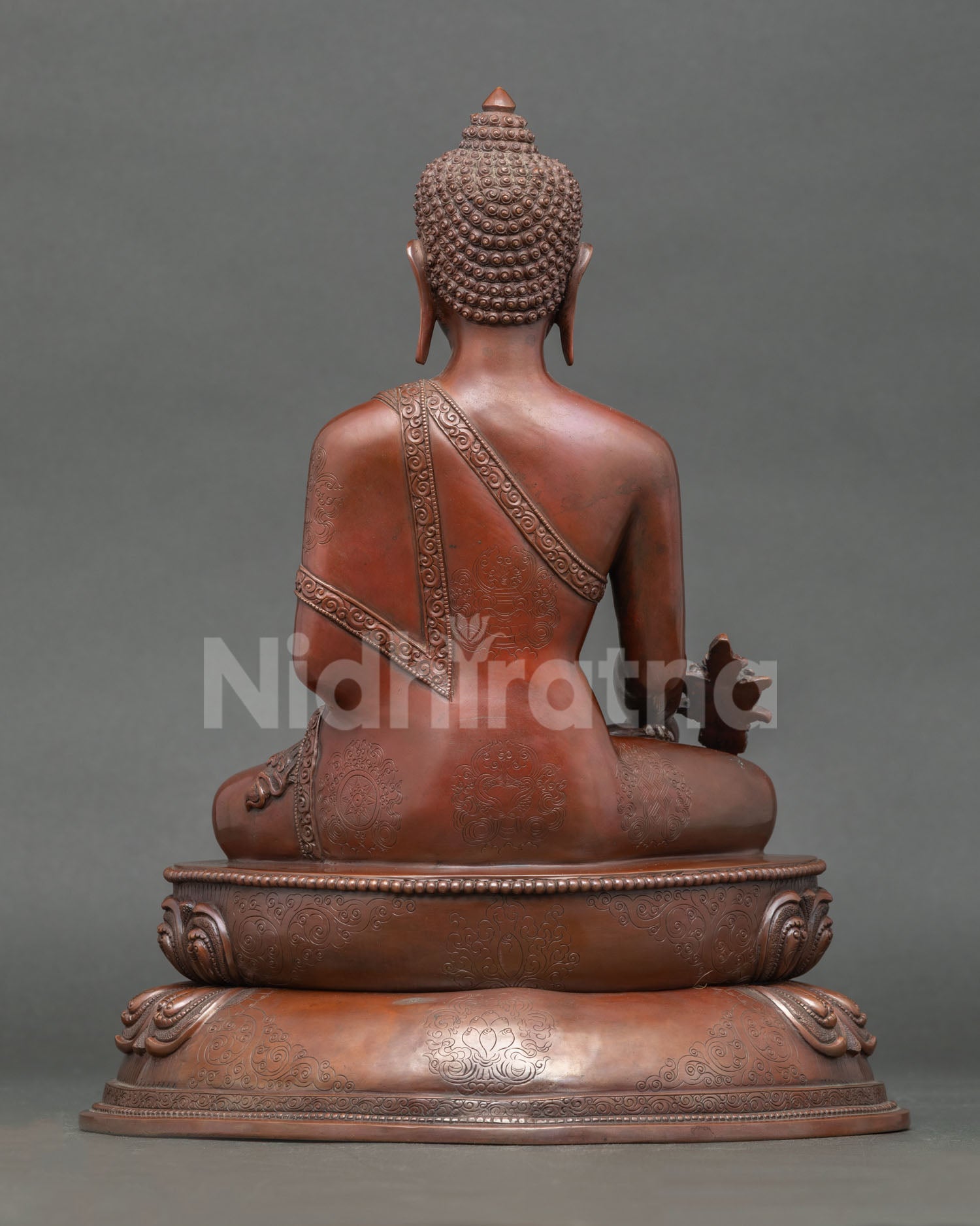 Back view of handmade Medicine Buddha statue with intricate Nepalese craftsmanship details
