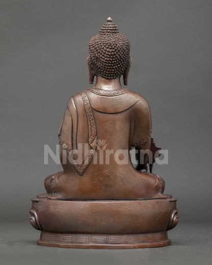 Back view of handmade Medicine Buddha statue with lost wax detail and Himalayan craftsmanship.

