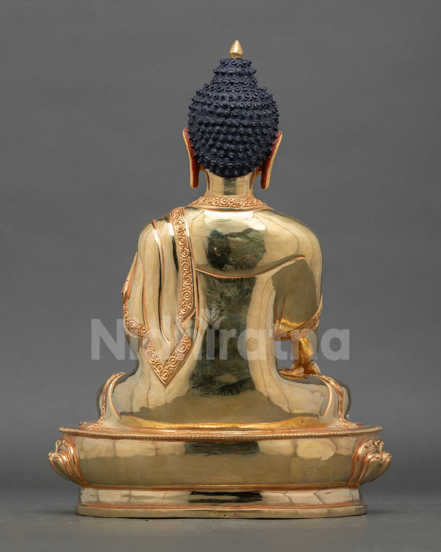 Back view of handmade Shakyamuni Buddha statue from Nepal with gold gilded finish and traditional Himalayan Buddhist artistry