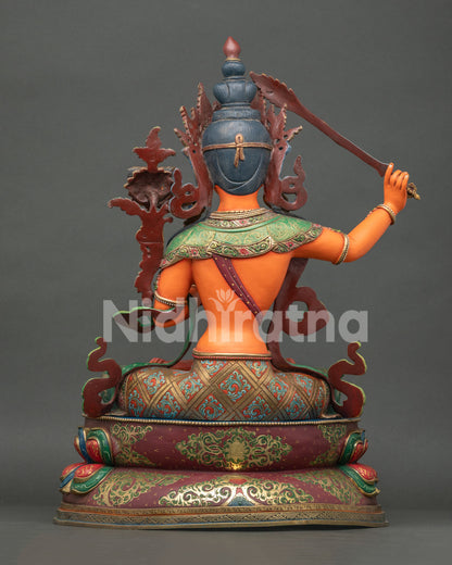 Back view of Large Manjushri statue showing ornate robes and copper craftsmanship
