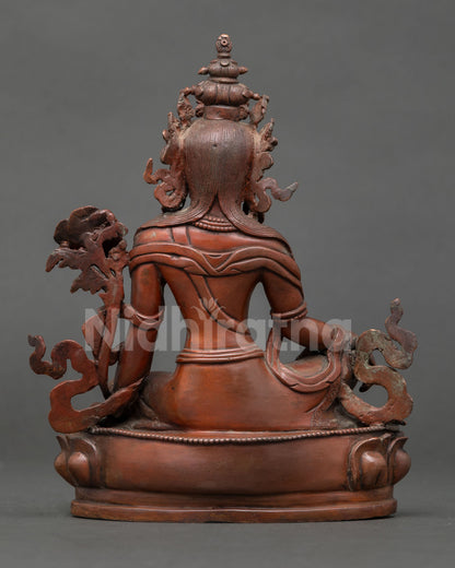 back view of lokeshvara statue showing detailed crown, robes, lotus base and oxidized copper texture