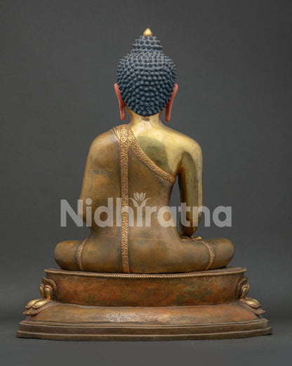 Back view of lost-wax copper Shakyamuni Buddha statue on lotus throne