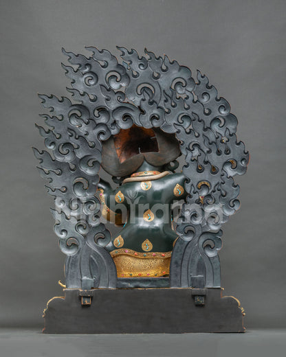 Back view of Mahakala Bernagchen statue showing openwork flame halo and pedestal