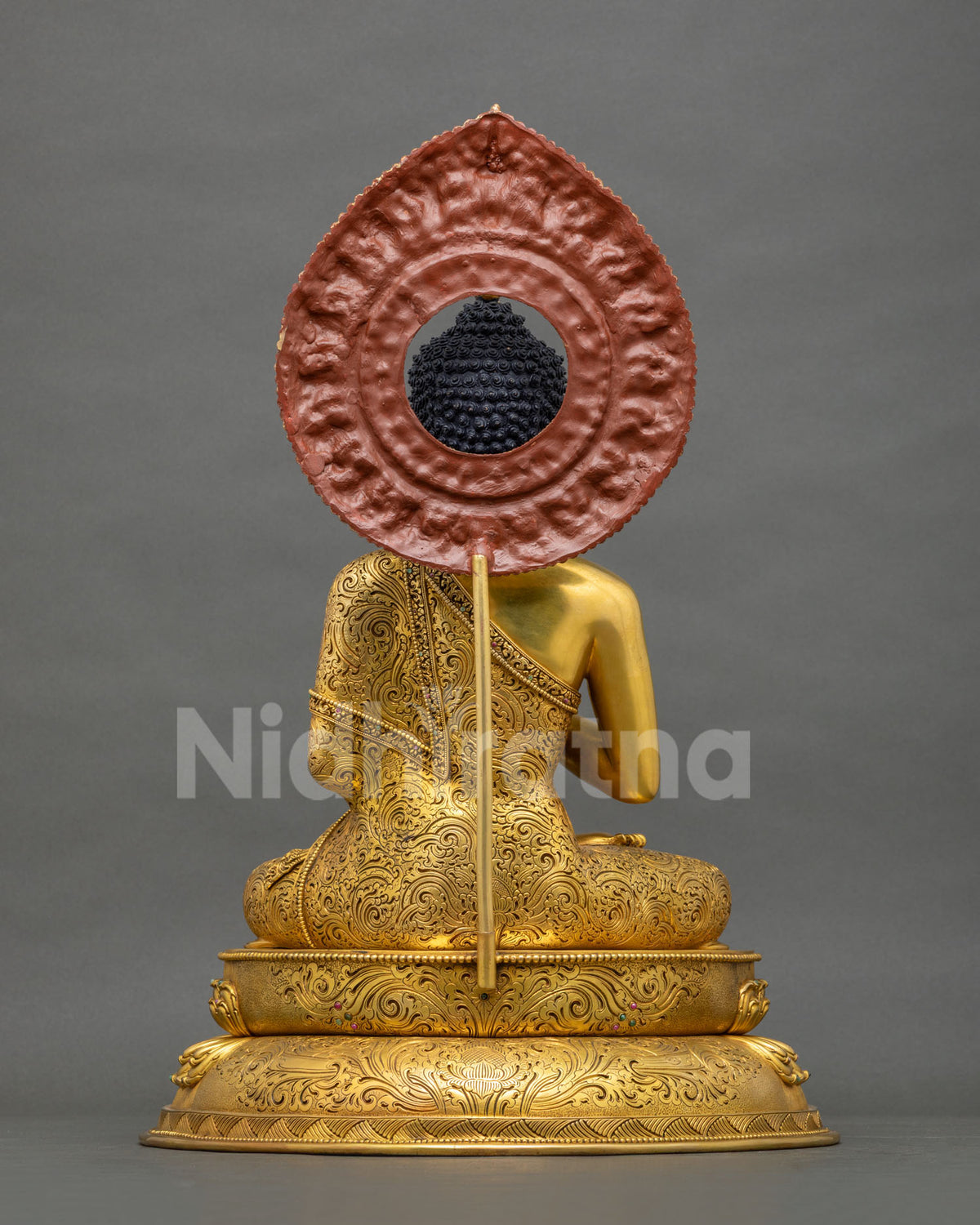 Back view of Maitreya Buddha statue from Nepal with hand-engraved robe, lotus base and copper halo