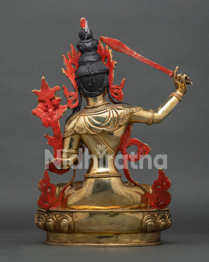 Back view of Manjushri statue displaying ornate halo and traditional copper craftsmanship