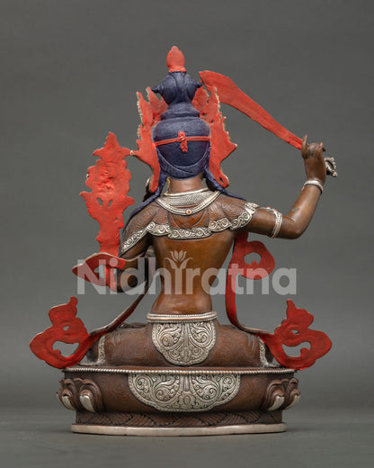 Back view of Manjushri statue revealing lost wax casting details and handcrafted Nepalese Buddhist metalwork