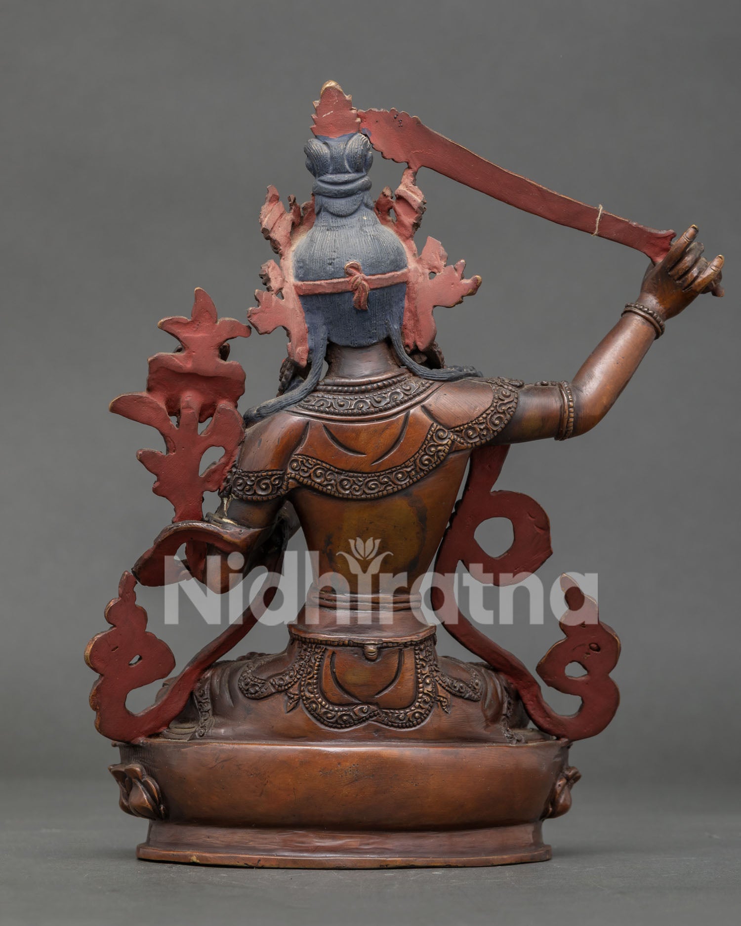 Back view of Manjushri statue showcasing handcrafted copper body and intricate Nepalese craftsmanship.