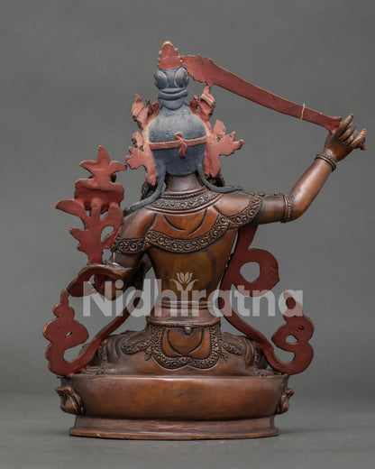 Back view of Manjushri statue showcasing handcrafted copper body and intricate Nepalese craftsmanship.