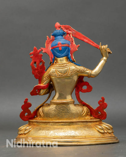 Back view of Manjushri statue showing detailed robes and lotus pedestal, handcrafted in Nepal.