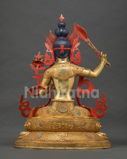 Back view of Manjushri statue showing gold gilded crown and lotus base, Nepal